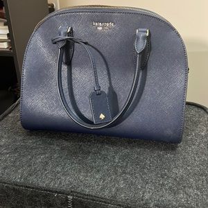 Blue oval shaped Kate Spade bag. Lots of room inside.